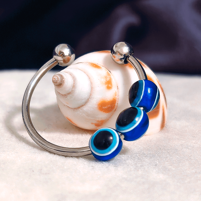 Paha silmä fidget sormus